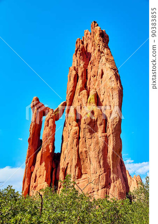 Mountain detail of large red rock pillar and boulders in desert 90383855