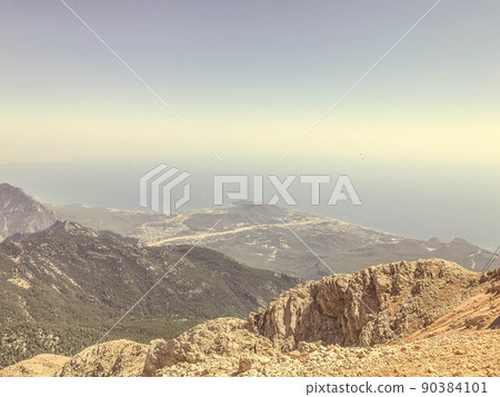 mountains against the blue sky. upland of stones and sand. grass and bushes grow on the mountain. leisure. hiking trails on the mountain, travel to hot countries mountains against the blue sky. upland of stones and sand. grass and bushes grow on the mountain. leisure. hiking trails on the mountain, travel to hot countries 90384101