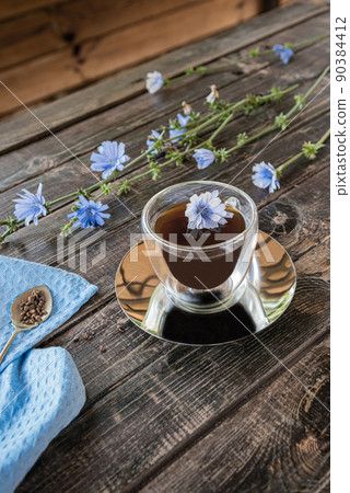 Chicory drink in thermo glass cup with fresh flowers Chicory drink in thermo glass cup with fresh flowers 90384412
