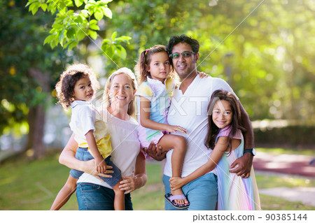 Family in summer park. Parents and kids outdoor. 90385144