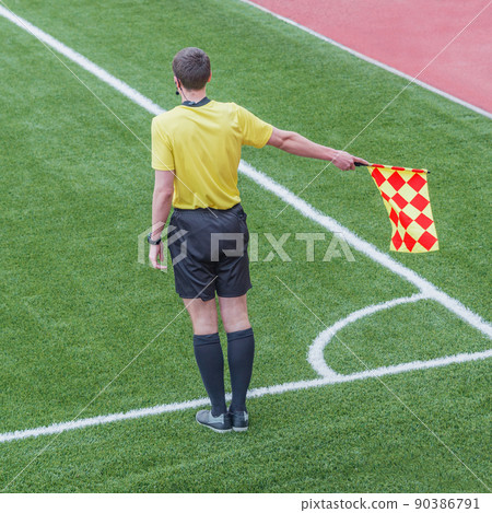 Referee from the sidelines of a soccer game. 90386791