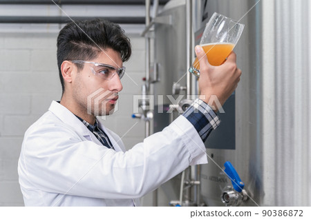Brewer testing beer at brewery factory Brewer testing beer at brewery factory 90386872