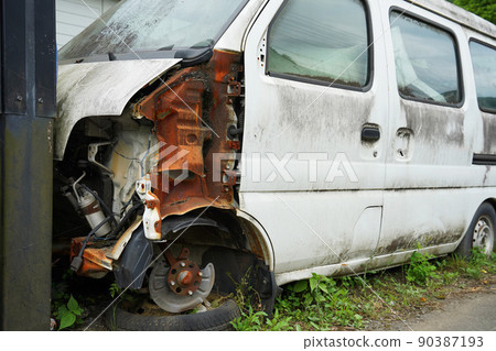A tattered car hitting a wall A tattered car hitting a wall 90387193