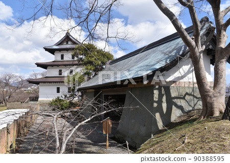 Matsumae Castle restored castle tower and existing Honmaru gate 90388595
