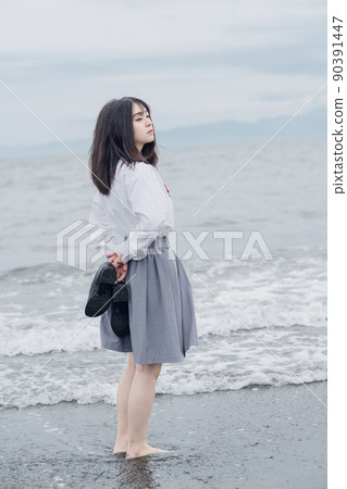 Schoolgirl on the beach 90391447