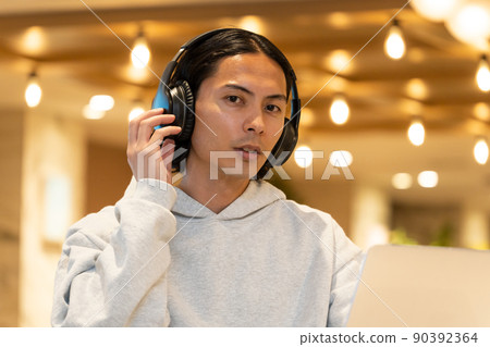 Young man wearing headphones Young man wearing headphones 90392364
