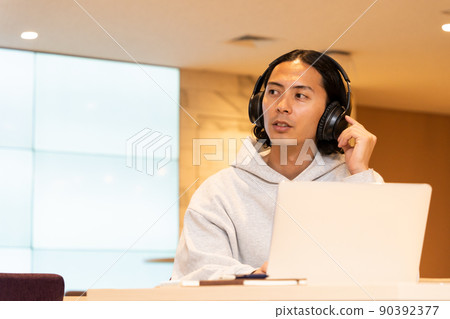 Young man wearing headphones Young man wearing headphones 90392377