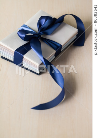 A special envelope bundled with a blue ribbon 90392643
