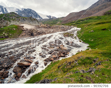 The bed of the mountain river became shallow after the flow of melt water, the dry season in the mountains. The bed of the mountain river became shallow after the flow of melt water, the dry season in the mountains. 90392708