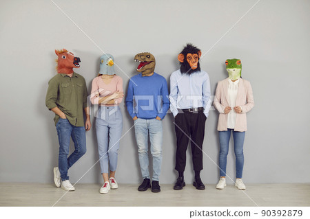 Group of people wearing funny strange absurd animal masks standing by office wall 90392879