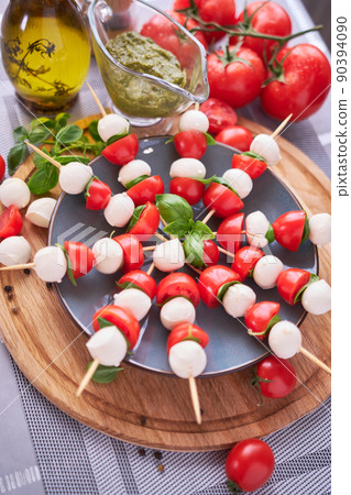 Caprese salad - Mini mozzarella cheese in glass bowl, tomato and basil 90394090