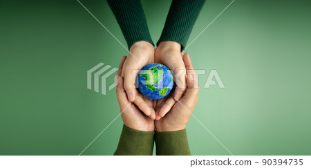 World Earth Day Concept. Green Energy, ESG, Renewable and Sustainable Resources. Environmental Care. Hands of People  Embracing a Handmade Globe. Protecting Planet Together. Top View 90394735
