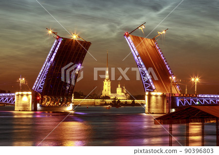 Symbol of Saint-Petersburg, Russia. Summer white night. Raising of Palace bridge over river Neva. The reflection of the illumination in the water. Symbol of Saint-Petersburg, Russia. Summer white night. Raising of Palace bridge over river Neva. The reflection of the illumination in the water. 90396803