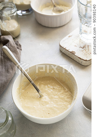 Homemade breadmaking with sourdough using wild yeast, busy lifestyle scene of baking at home, top view. Sustainable living 90398140