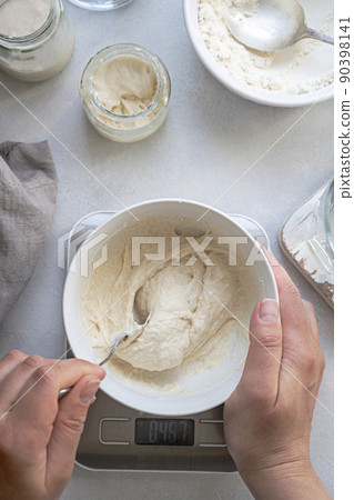 Homemade breadmaking with sourdough using wild yeast, busy lifestyle scene of baking at home, top view. Sustainable living Homemade breadmaking with sourdough using wild yeast, busy lifestyle scene of baking at home, top view. Sustainable living 90398141
