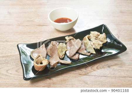 boiled entrails with chop pork on black plate dipping spicy and sour chili sauce boiled entrails with chop pork on black plate dipping spicy and sour chili sauce 90401188