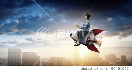 Kid wearing headphones on a rocket Kid wearing headphones on a rocket 90401622