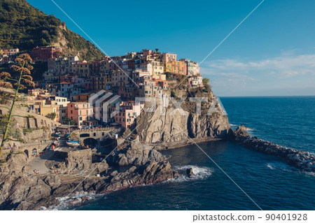 Rocky hills and colorful historic buildings of Manarola, Italy. Rocky hills and colorful historic buildings of Manarola, Italy. 90401928