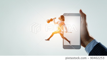 Young pretty businesswoman playing violin Young pretty businesswoman playing violin 90402253