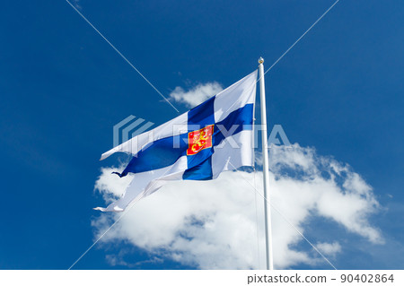 State flag of Finland with national coat of arms against blue sky on the wind State flag of Finland with national coat of arms against blue sky on the wind 90402864