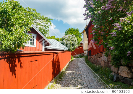 Beautiful street with old wooden houses and blooming lilac in old town of Porvoo Beautiful street with old wooden houses and blooming lilac in old town of Porvoo 90403103