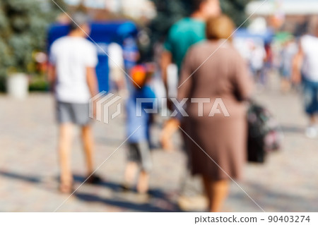 Blurred defocused abstract background of people walking on the city street. Unrecognizable faces 90403274