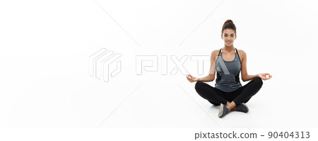 Healthy and Fitness concept - Beautiful American African lady in fitness clothing doing yoga and meditation. Isolated on white background. Healthy and Fitness concept - Beautiful American African lady in fitness clothing doing yoga and meditation. Isolated on white background. 90404313