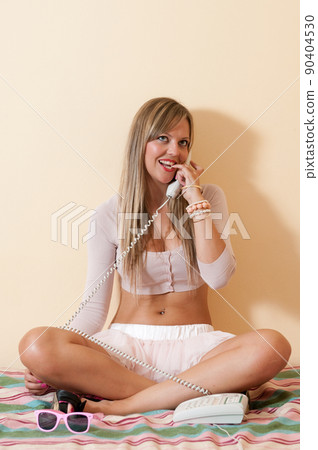 young woman at home, talking on the phone young woman at home, talking on the phone 90404530