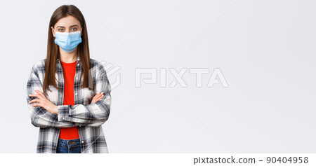Coronavirus outbreak, leisure on quarantine, social distancing and emotions concept. Confident young woman in checked shirt wear medical mask, cross arms chest, determined look camera Coronavirus outbreak, leisure on quarantine, social distancing and emotions concept. Confident young woman in checked shirt wear medical mask, cross arms chest, determined look camera 90404958