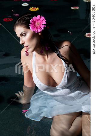 Clothed woman taking a bath at sunset 90405008