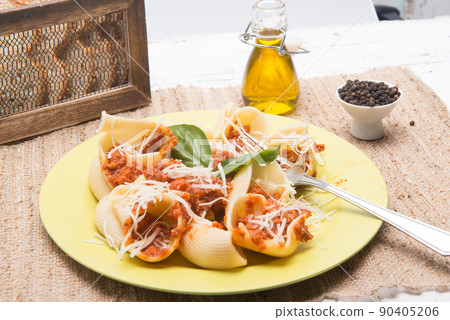 shell type pasta dish with meat served on table shell type pasta dish with meat served on table 90405206