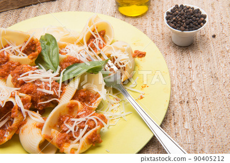 shell type pasta dish with meat served on table shell type pasta dish with meat served on table 90405212