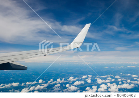 Plain wing over blue sky. Flight from Helsinki to Amsterdam. 90406408