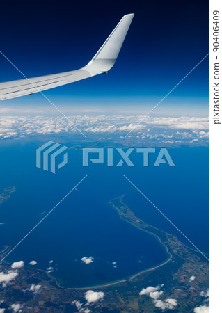 Plain wing over blue sky. Flight from Helsinki to Amsterdam. Plain wing over blue sky. Flight from Helsinki to Amsterdam. 90406409