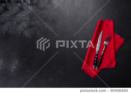 Christmas table setting with empty black ceramic plate, fir tree and black accessories Christmas table setting with empty black ceramic plate, fir tree and black accessories 90406800