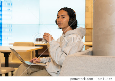 Young man wearing headphones Young man wearing headphones 90410856
