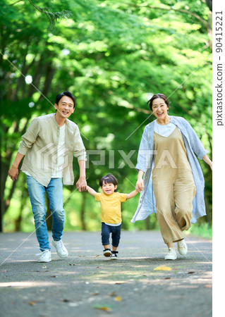 A family running hand in hand 90415221