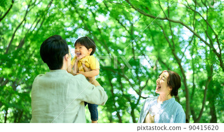 Family touching in the fresh green 90415620