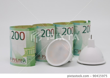 White electric cable and banknotes, expensive electricity, saving electricity. 90415975