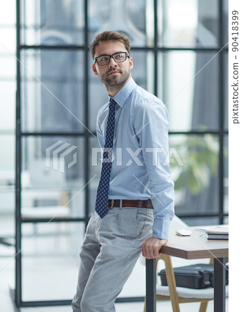 Young businessman working at modern glass office 90418399