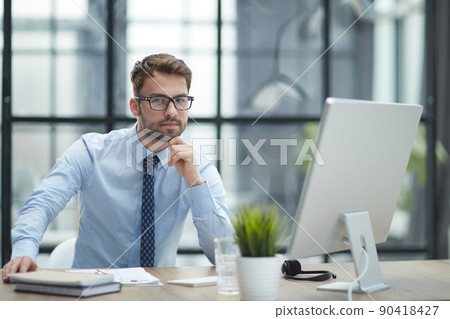 Young businessman working at modern glass office 90418427