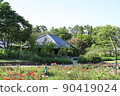 Watermill in a flower field in the blue sky 90419024