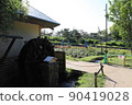 Watermill in a flower field in the blue sky 90419028