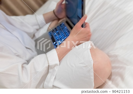 Image of female remote work business trip worcation using a personal computer in bed Image of female remote work business trip worcation using a personal computer in bed 90421153
