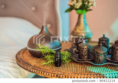 Aroma oil diffuser with aroma oil on table at home. Air freshener 90421214