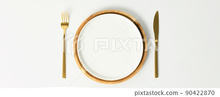 Stylish table setting, empty white and wood plates with fork and knife on white background, mock up Stylish table setting, empty white and wood plates with fork and knife on white background, mock up 90422870