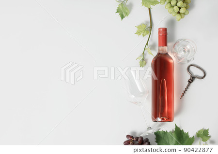 Bottle of Rose wine and grape. Flat-lay of rose wine on white background Bottle of Rose wine and grape. Flat-lay of rose wine on white background 90422877