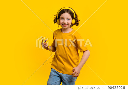 Girl dancing listening to music with headphones Girl dancing listening to music with headphones 90422926