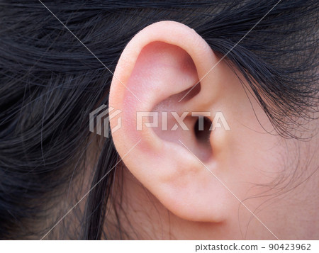 Female human ear closeup 90423962