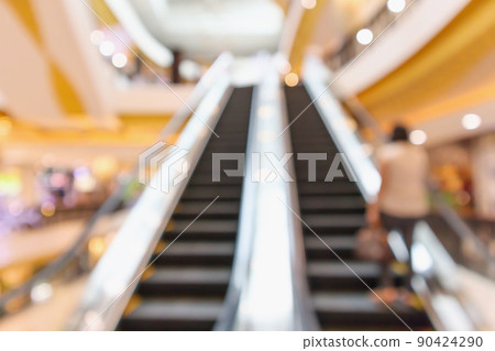 Abstract blur escalators at the modern shopping mall interior defocused background Abstract blur escalators at the modern shopping mall interior defocused background 90424290